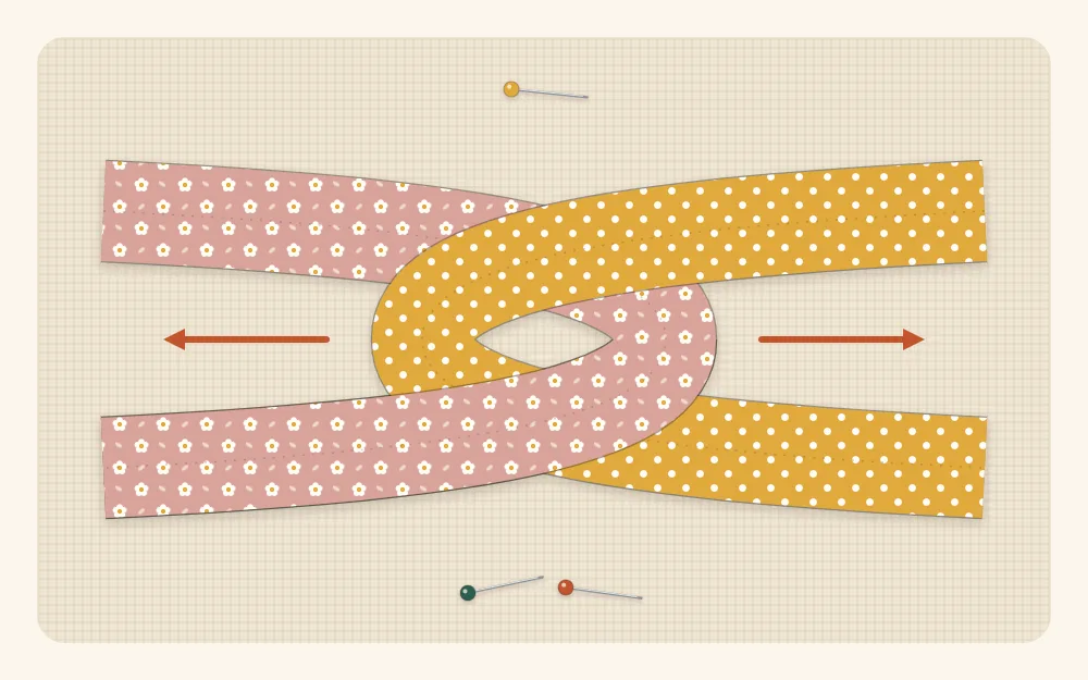 Flat illustration of two fabric tubes in different prints, each folded in half and looped through the other to form a twist