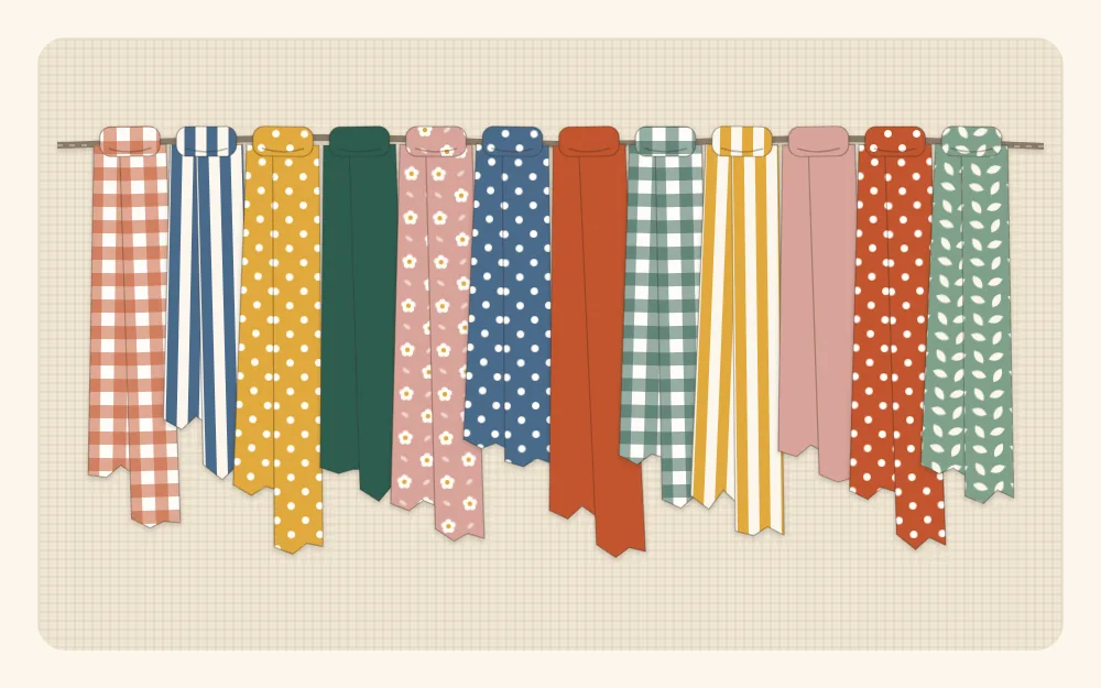Torn fabric strips in mixed prints knotted side by side along a length of twine