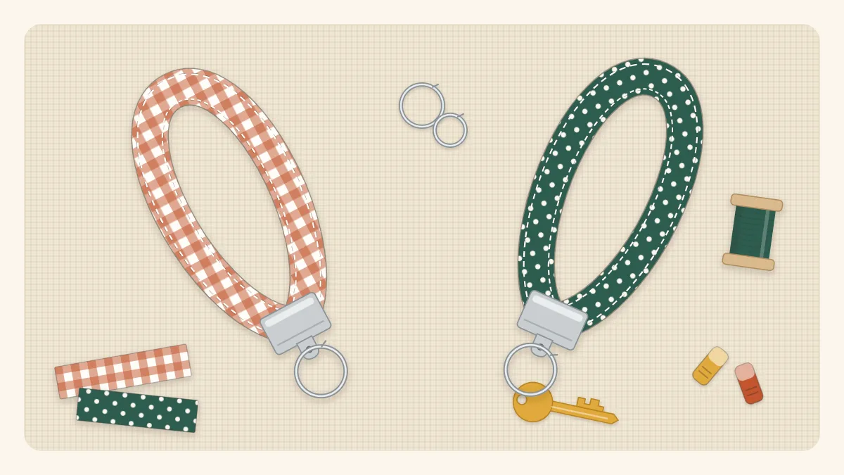 Flat illustration of two fabric key fobs in different prints, each with a metal clamp and a key ring