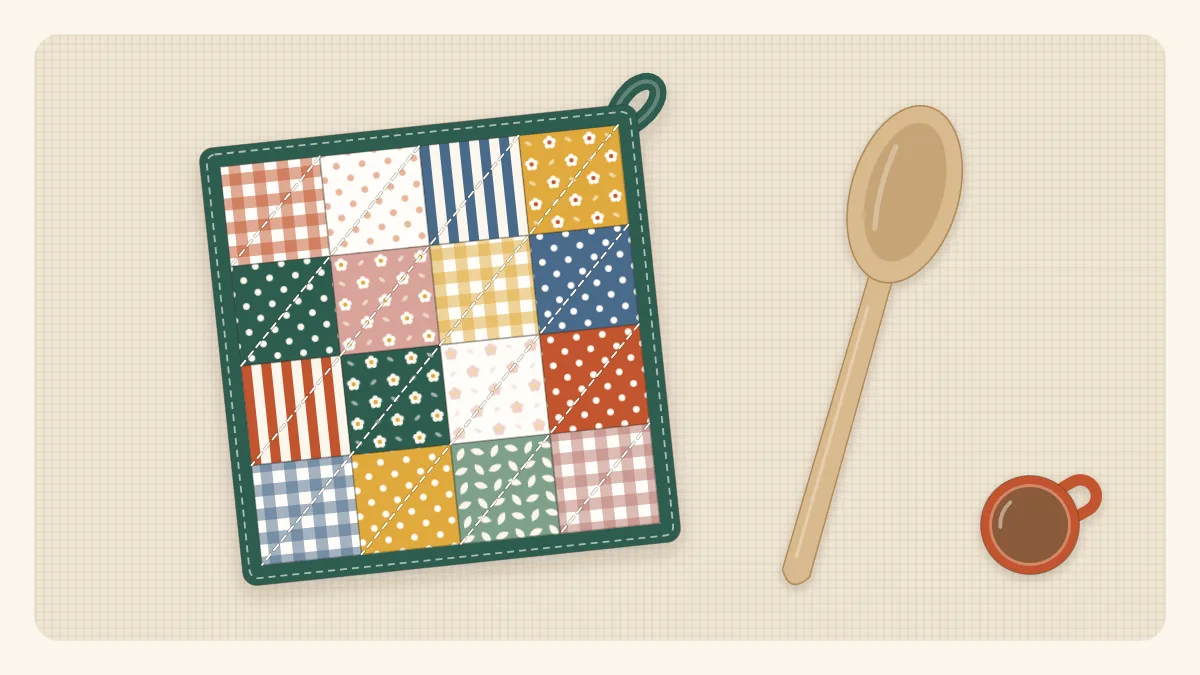 A square patchwork pot holder with a hanging loop next to a wooden spoon